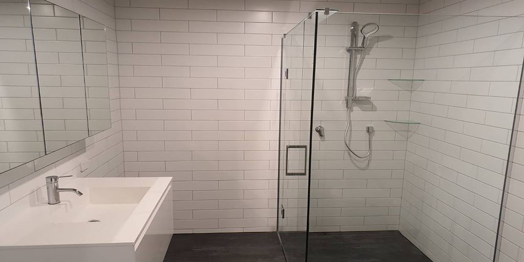 White and black bathroom with a sink and shower